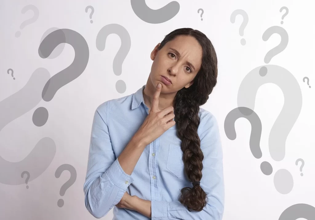 A woman surrounded by question marks